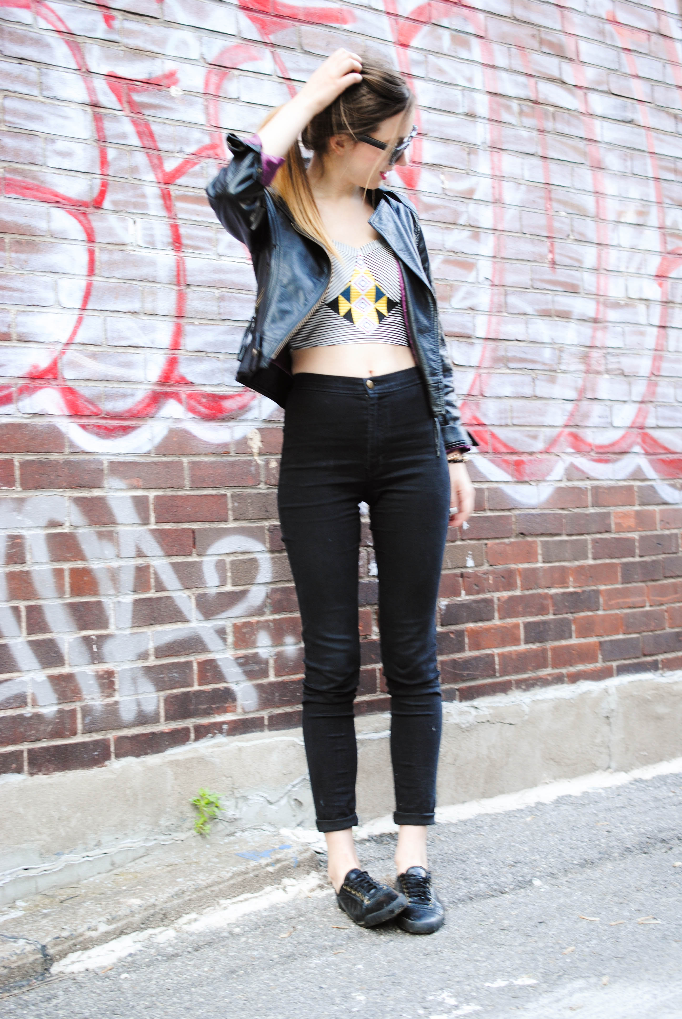 high waisted black jeans, crop top and leather jacket