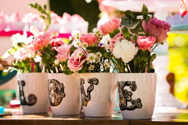Love in cup with flowers for wedding