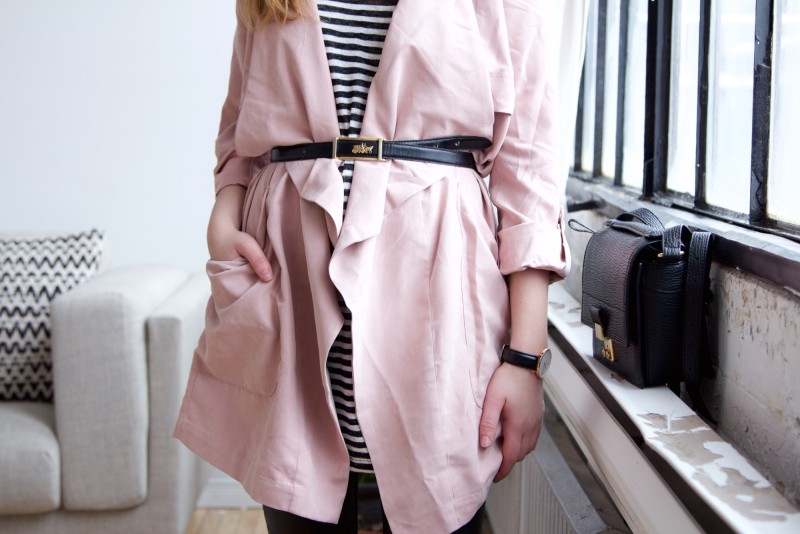 belted coat over striped tunic and leather pants